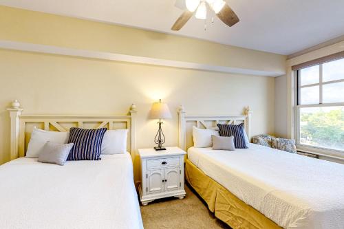 two beds sitting next to each other in a bedroom at Baytowne Wharf - Observation Point North #460 in Destin