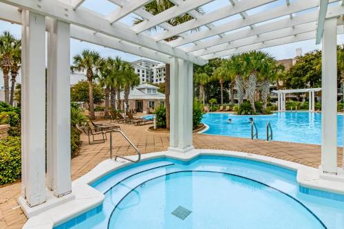 an outdoor pool with a pergola and a swimming pool at Baytowne Wharf - Observation Point North #460 in Destin