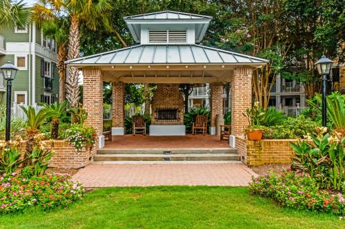 a gazebo with a table and chairs in a yard at Baytowne Wharf - Observation Point North #460 in Destin