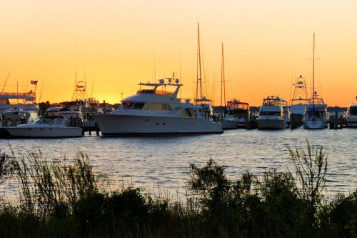 a group of boats docked in a harbor at sunset at Baytowne Wharf - Observation Point North #460 in Destin