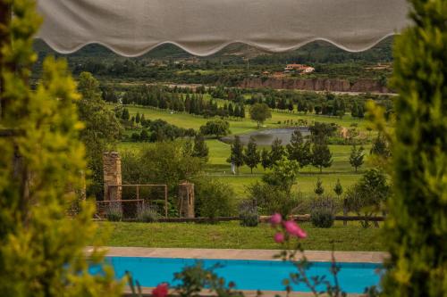 a view of a golf course from the window of a house at Casa de Campo La Montaña in Tarija