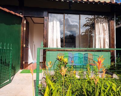 a house with a green fence and a window at FLOR DE PARAISO BUNGALOWS in Montezuma