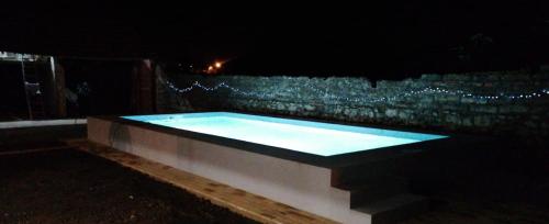 a swimming pool lit up at night with lights at Casa da Avó do Puto in Mealhada