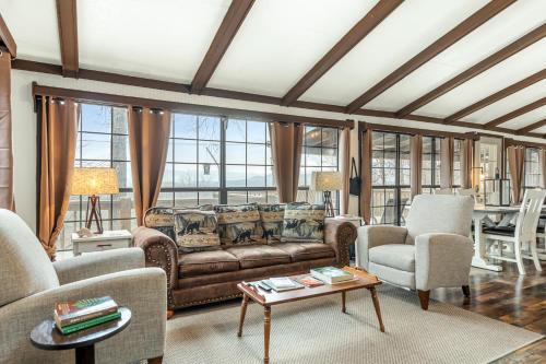 a living room with a couch and chairs and a table at Eagle's Nest in Franklin