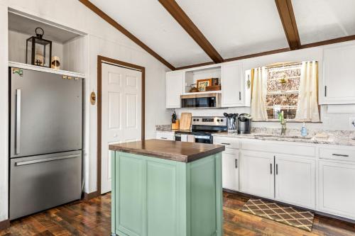 a kitchen with white cabinets and a stainless steel refrigerator at Eagle's Nest in Franklin