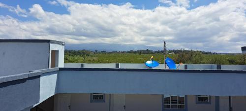 a building with two blue chairs on the roof at Nice Place in Ol Pejeta Conservancy