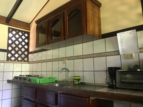 a kitchen with a sink and a counter top at FLOR DE PARAISO BUNGALOWS in Montezuma