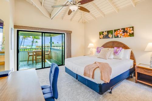 a bedroom with a bed and a dining table and a balcony at Poipu Sands 221 in Koloa