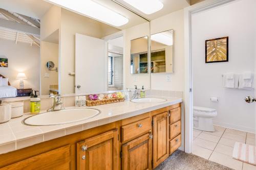 a bathroom with two sinks and a toilet at Poipu Sands 221 in Koloa
