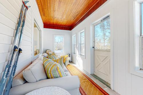 a living room with a couch and a wooden ceiling at A Villager's Dream in North Conway