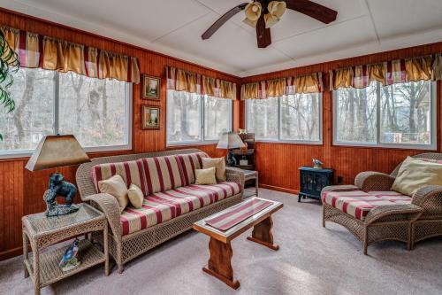a living room with a couch and chairs and windows at The Bird House in Dillard