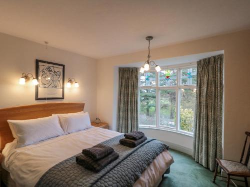a bedroom with a bed and a large window at Clover Leaf in Guisborough
