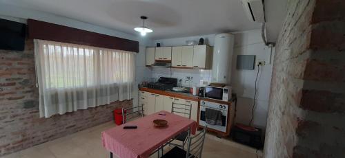 a small kitchen with a table and a pink table cloth at Apart Hotel Red Dto 1 in Pontevedra