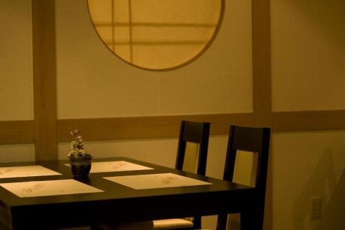 a dining room table with two chairs and a mirror at Mikasa in Nara