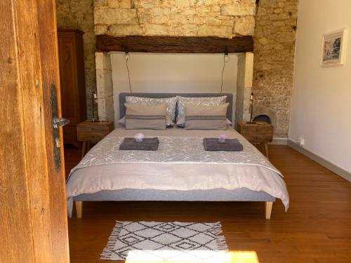 a bedroom with a bed with two trays on it at Picturesque renovated farmhouse with pool in Les Junies