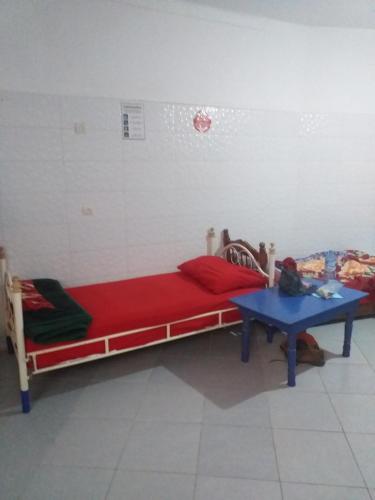 a bedroom with a bed and a table in it at White And Blue in Essaouira