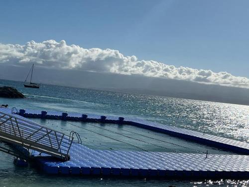 a dock in the ocean with a boat in the water at Bella vista house 971 in Le Gosier