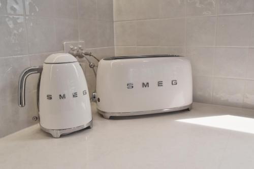 two toasters sitting on a counter in a bathroom at The Noosa Apartments in Noosa Heads