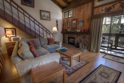 a living room with a couch and a fireplace at Bear Lake Hideaway condo in South Lake Tahoe