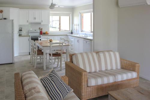 a kitchen with a table and a chair and a dining room at 2 51 Carlo Road Rainbow Beach in Rainbow Beach