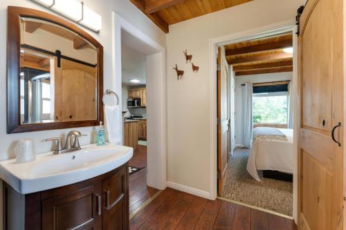 a bathroom with a sink and a bedroom at Stone Lizard Lodge in Blanding