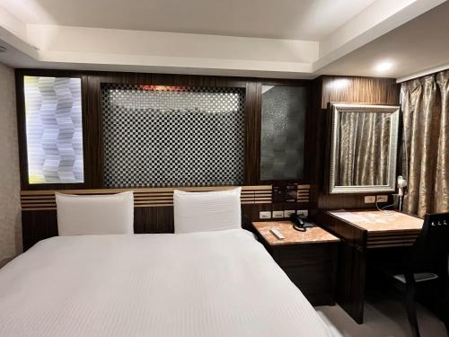 Postel nebo postele na pokoji v ubytování Guide Hotel Taipei Xinyi