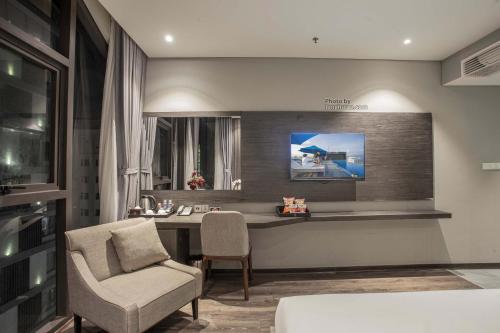 a living room with a desk and a chair at Grand Ocean Luxury Boutique - Infinity Rooftop Pool in Da Nang