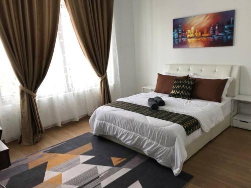 a bedroom with a large bed and a large window at Elmina near Denai Alam, Saujana Utama with Wi-Fi & Netflix in Shah Alam