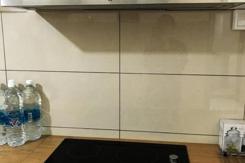two bottles of water are sitting next to a wall at Elmina near Denai Alam, Saujana Utama with Wi-Fi & Netflix in Shah Alam