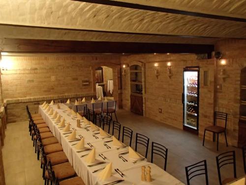 a large room with tables and chairs in it at Kastélykert Fogadó in Szeged