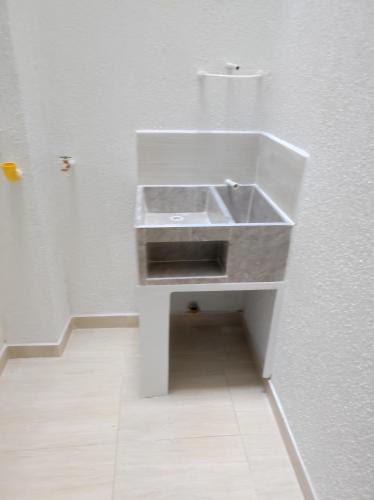 a bathroom with a sink in a white wall at Apartamento portal del prado in Santa Rosa de Cabal