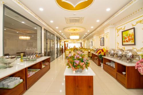 a restaurant with flowers on the counters and tables at Anh Thảo Hotel Quy Nhơn in Quy Nhon