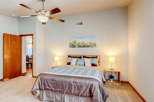 a bedroom with a bed and a ceiling fan at Speedway House in Port Orange