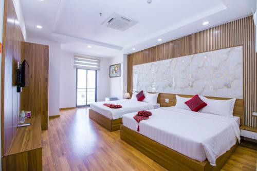 Giường trong phòng chung tại Anh Thảo Hotel Quy Nhơn