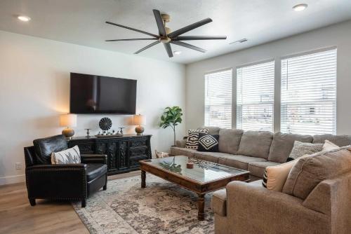 a living room with a couch and a flat screen tv at Desert Azul townhouse in St. George
