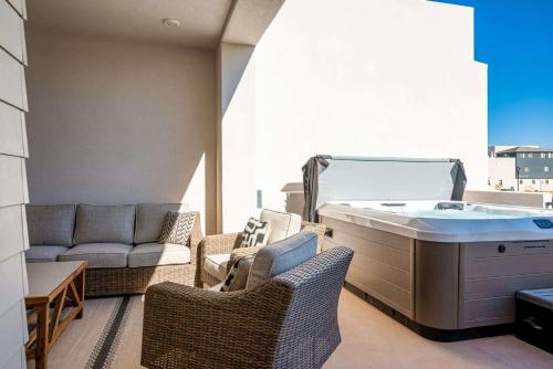 a balcony with a hot tub and a couch at Desert Azul townhouse in St. George