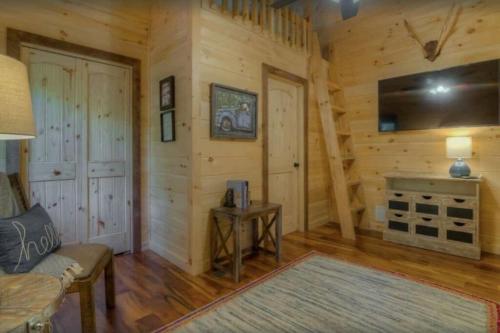 a living room with a fireplace in a log cabin at Sky High Lodge - Blue Ridge in Blue Ridge