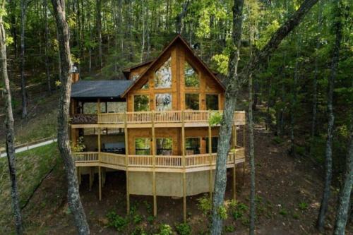 a house in the woods with a wrap around deck at Sky High Lodge - Blue Ridge in Blue Ridge