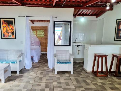 a room with a bed and a table and chairs at Isla Cébaco in Isla Cebaco 