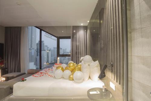 a hotel room with a bed with balloons on it at Grand Ocean Luxury Boutique - Infinity Rooftop Pool in Da Nang
