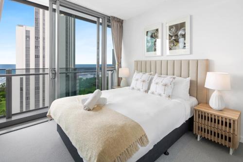 a bedroom with a large bed with a large window at CASSA SIGNATURE - Luxury Apartments Managed by The Cassa in Gold Coast