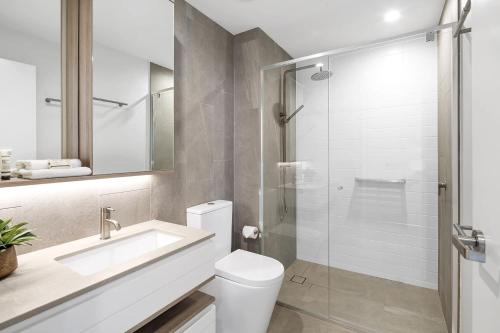 a bathroom with a toilet and a sink and a shower at CASSA SIGNATURE - Luxury Apartments Managed by The Cassa in Gold Coast