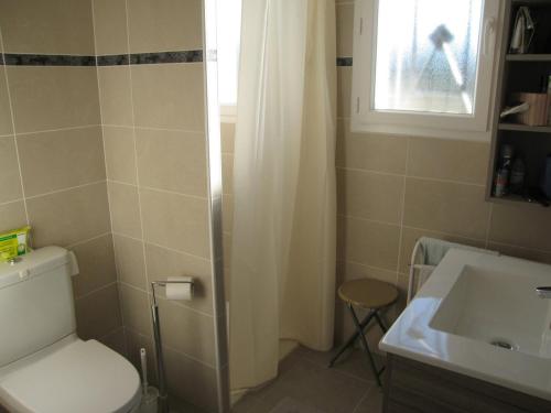 a bathroom with a toilet and a sink and a window at Villa Saint-Cyprien, 4 pièces, 6 personnes - FR-1-106-40 in Saint-Cyprien