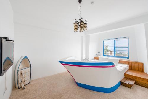 a boat sitting in a living room with a chandelier at White Lighthouse in Xiaoliuqiu
