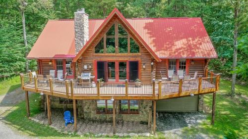 a log cabin with a deck and a porch at Rock Lodge Cabin in McHenry