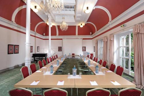 a large room with a long table and chairs at Hotel Baseler Hof in Hamburg