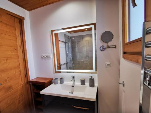 a bathroom with a sink and a mirror at Appartement rénové 4* aux Gets, 6 pers, parking inclus - FR-1-598-127 in Les Gets