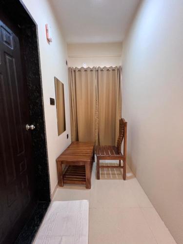 a room with a wooden bench and a door at Hotel Mangalore Stay INN in Mangalore