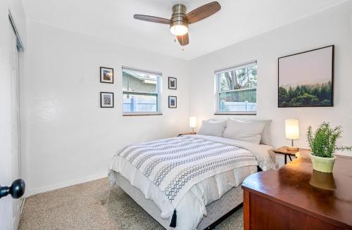 a bedroom with a bed and a ceiling fan at Upscale 2br House Wprivate Yard & Parking in St. Petersburg