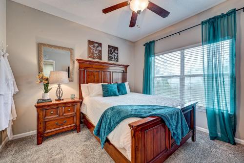 a bedroom with a bed and a dresser and a window at Westside Retreat with Private Balcony Nr DWTN Jax in Jacksonville